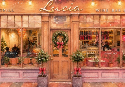 Festive storefront of Lucia Grill Wine Bar decorated with Christmas wreaths, red bows, garlands, and hanging ornaments, featuring sections for Gelateria, Pizzeria, Wine Bar and Lounge Bar with large display windows and wooden doors